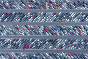 Parking lot experiencing heavy vehicle movement and congestion.