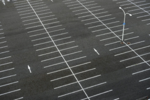Newly paved parking lot with a smooth asphalt surface and no visible cracks.