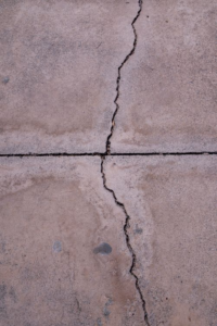 A close-up of a crack running through a concrete surface